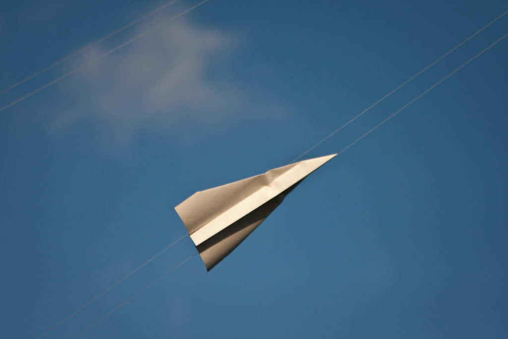 Paper aeroplane in blue sky